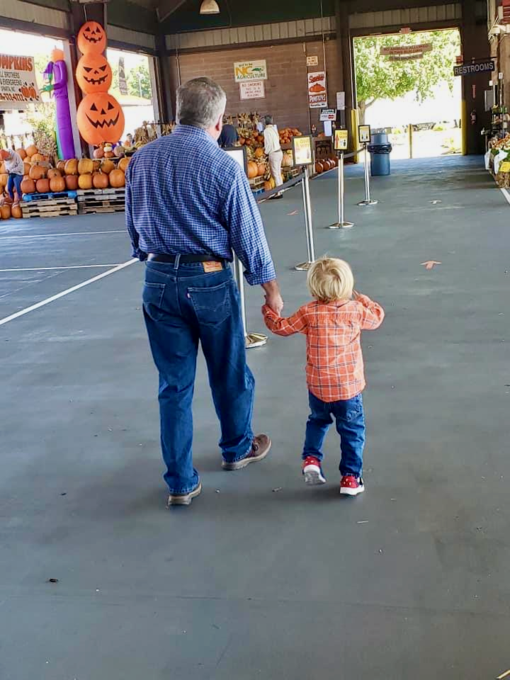 Dad with family at pumpkin patch